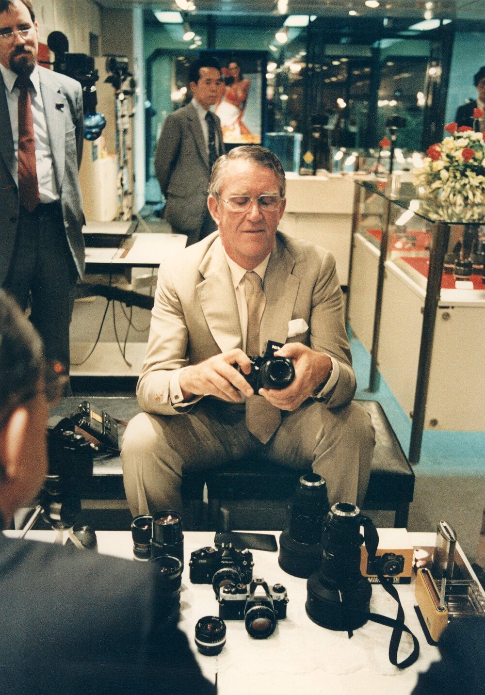 Malcolm Fraser examining a camera during a visit to Japan.