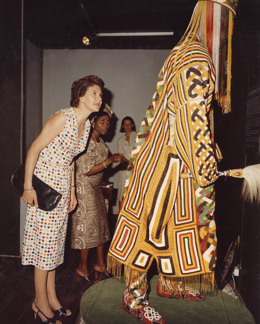 Tamie Fraser studying a dressed mannequin at an exhibition of local art in Nigeria.