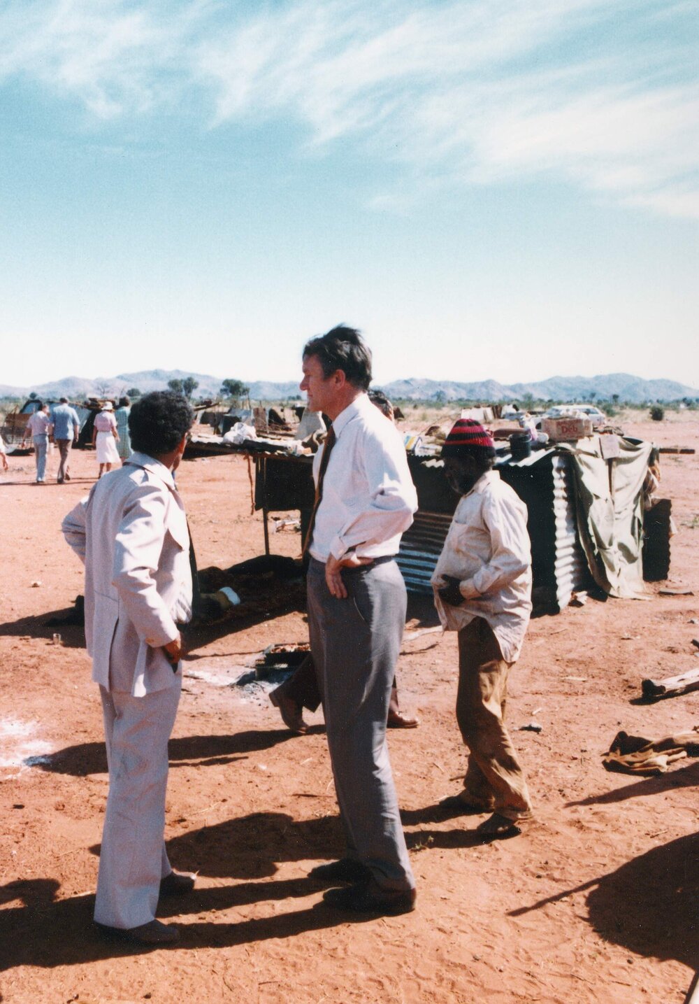 Malcolm Fraser and Charles Perkins visiting an Aboriginal Australian settlement in the Northern Territory.