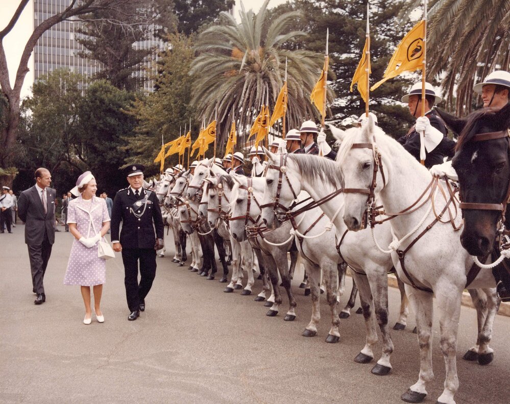 Queen Elizabeth II and the Duke of Edinburgh inspecting a row of mounted police in Perth, Western Australia, during their 1977 official visit to Australia.