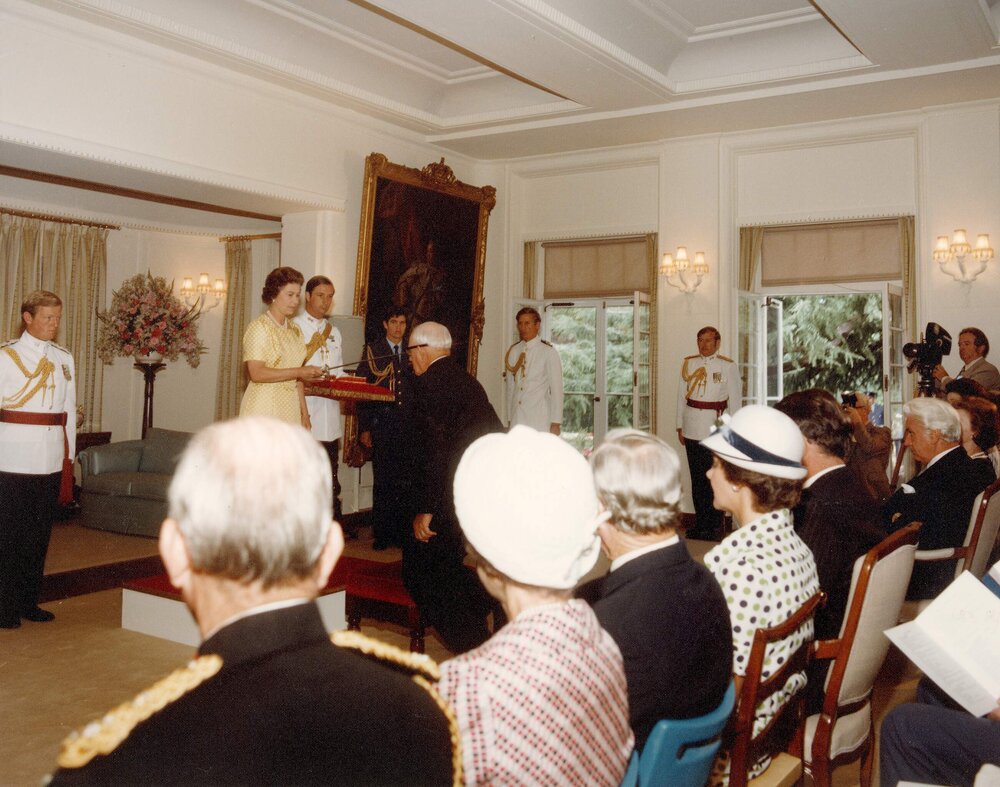 Queen Elizabeth II knighting an unidentified man at Government House Canberra, Australian Capital Territory.