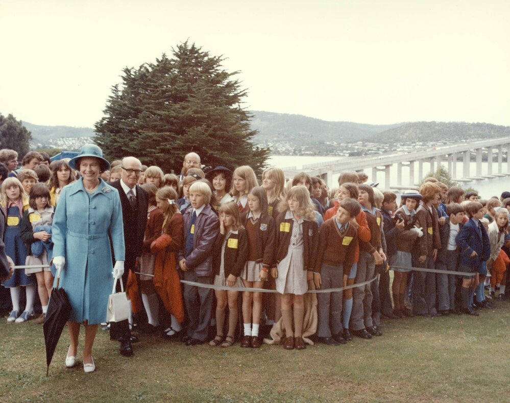 Queen Elizabeth IIand Sir Stanley Burbury, the Governor of Tasmania, with a group of school student in Hobart. Taken during the Queen's 1977 official Australian visit.