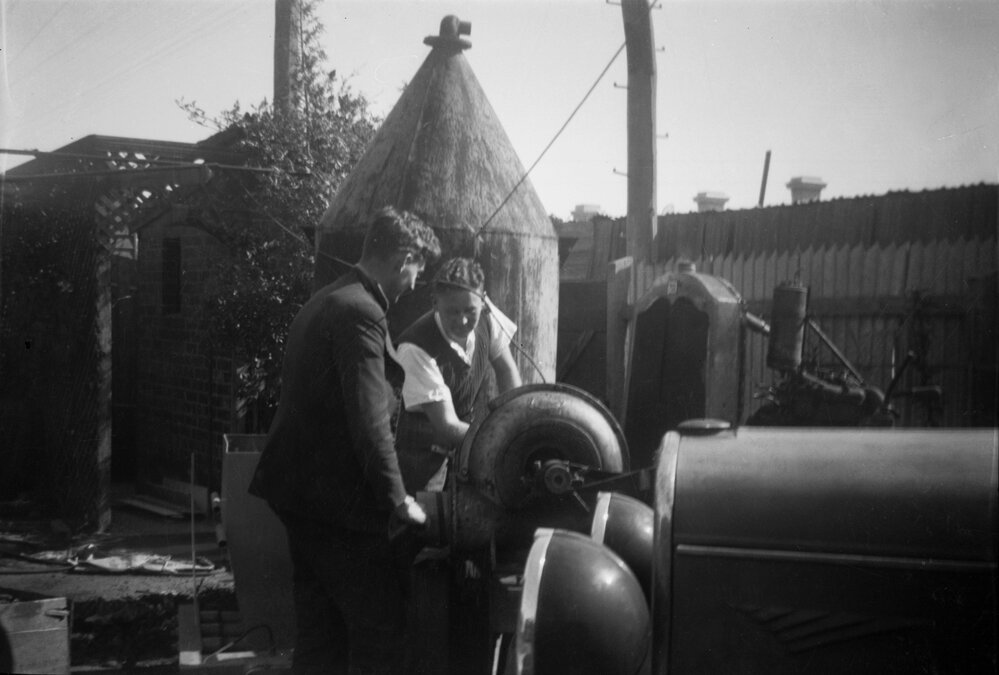 Two men studying unknown machinery