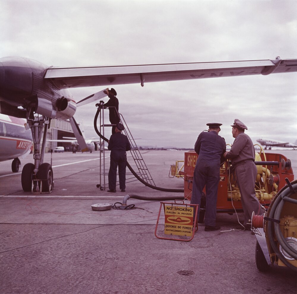 Aircraft refuellers using Shell pumping equipment to refuel an Ansett-ANA Fokker F27 Friendship