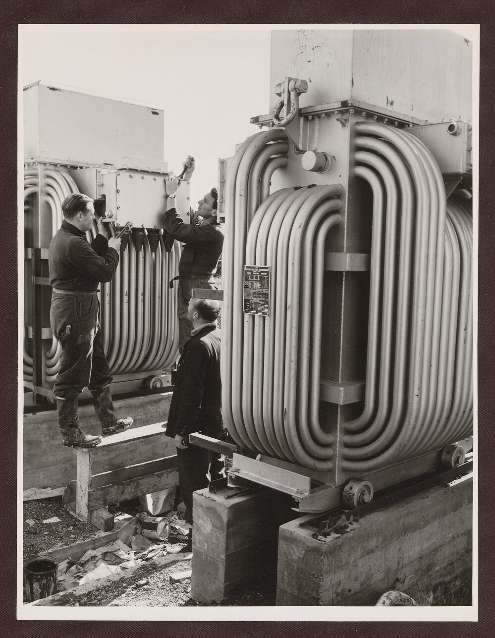 Workman at  flue duets at main boiler plant.