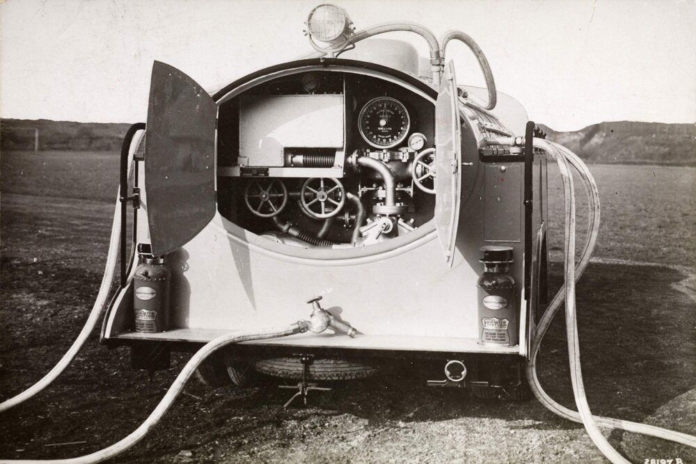 The rear view of a Ford Sussex pump tanker with doors open showing the pump and hose