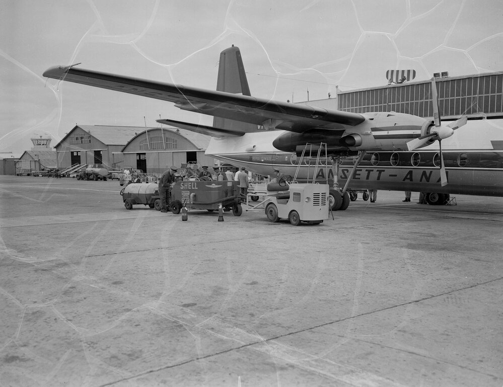 An Ansett-ANA Fokker F27 Friendship being refuelled by Shell Australia workers in front of terminal buildings at an unidentified Australian airport