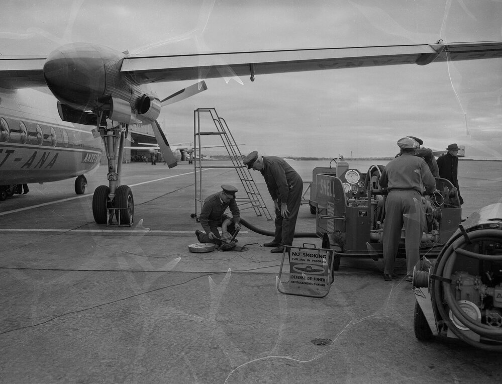 An Ansett-ANA Fokker F27 Friendship being refuelled by Shell Australia workers on the apron of an unidentified Australian airport.