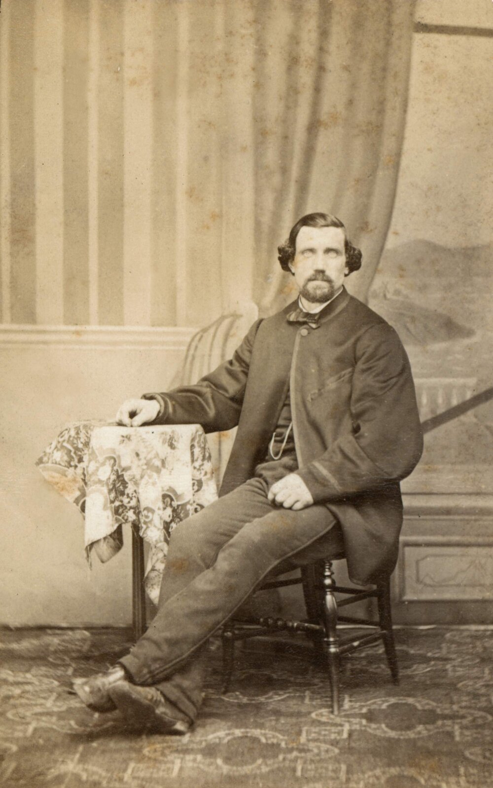 Studio portrait of an unidentified man wearing a frock coat.