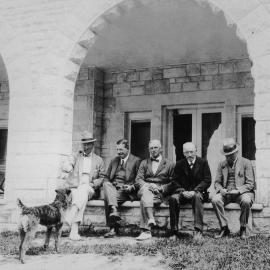 Five unidentified men and a dog