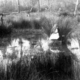 Children playing (hide and seek?) in wetland