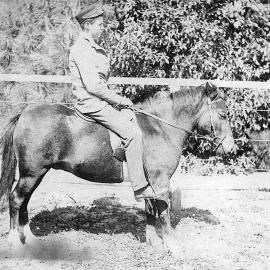 Young man on horse, dressed in uniform