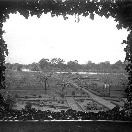 Ivy framed view of garden and orchard