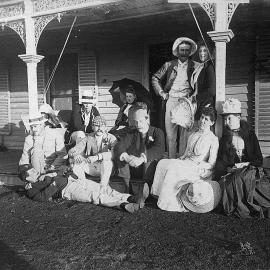 A group of people on a low verandah