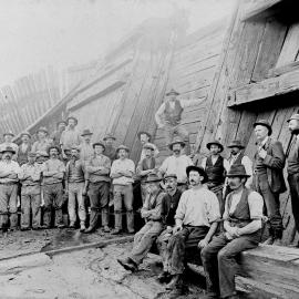 Group of workers at river end of dock