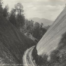A large railway cutting and newly laid track on the Mount Lyell Railway in Tasmania.