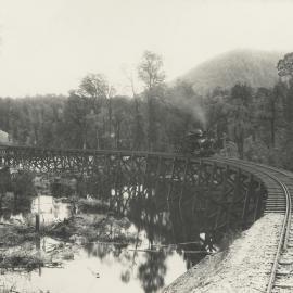 A view of a timber trestle railway bridge crossing the King River, Tasmania, constructed by Mount Lyell Mining and Railway Co. Ltd.