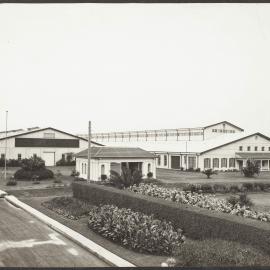 Two factory site sheds, one with sign stating 'Wolseley motor cars'