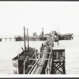 The Broken Hill proprietary company limited, loading iron ore by means of conveyor belt at the jetty.