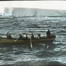 Berg aground near Cape Evans. Boat coming off. Terra Nova aground.