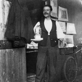 Walter E Bennett carrying tea in a studio in Sydney
