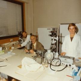 Professor Michael J D White in Laboratory with Two Others