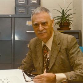 Professor Michael J D White seated at desk