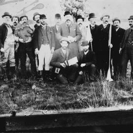 A group of men possibly at a greyhound racing event.
