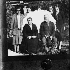 Group of six women surrounding a man.