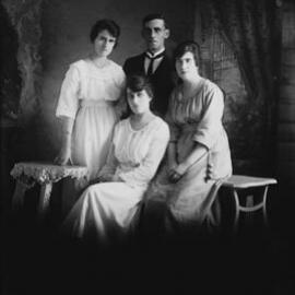Studio group portrait of three women and a man.  Family name Russell.