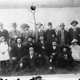 A posed group of unidentified people in an outdoor setting.