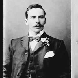 Studio portrait of an unidentified young man wearing a bow tie.