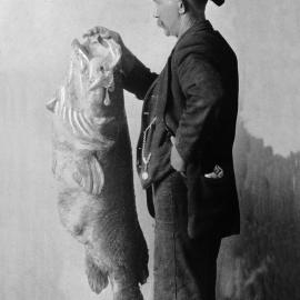 An unidentified man holding a Murray Cod fish.