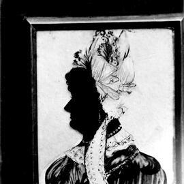 Drawing of a silhouetted woman wearing a hat.