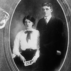 Portrait of a seated woman and a standing man.