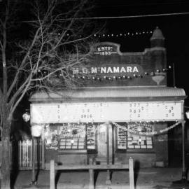 An illuminated display on the front of M.Q. McNamara's shop for the Coronation of King George 5th.