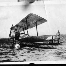 A Sopwith WW1 biplane aircraft in an unknown location.