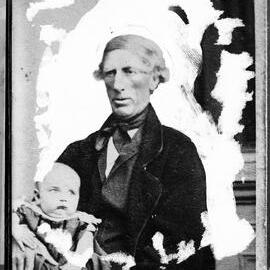 Portrait of an unidentified  man holding a baby.