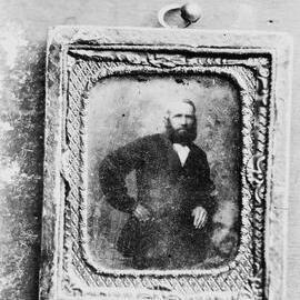A framed portrait of an unidentified standing man.