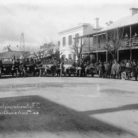 Men and cars spread across the road in central Benalla, preparing to depart for Dookie, 2nd August 1919.