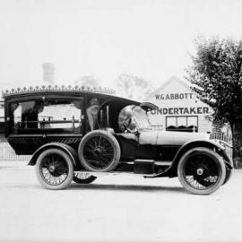 A motor hearse outside the premises of W. G. Abbott, Undertaker, Benalla.