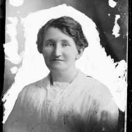 Portrait of an unidentified woman in a white blouse.