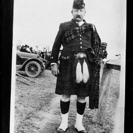 An unidentified man in a Scottish highland costume.