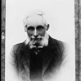 An unidentified man with white hair and unkempt beard.