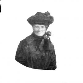 An unidentified woman wearing a hat and scarf.