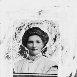 Portrait of an unidentified woman wearing a double strand pearl necklace.