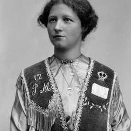 Portrait of Miss McCoy wearing an embroidered vest of unknown symbolism.