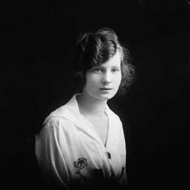 Studio half-length portrait of a young woman.