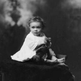 Portrait of an unidentified baby on a fur rug.