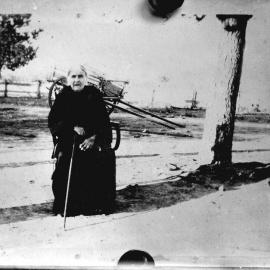 An unidentified elderly woman in a farm environment.
